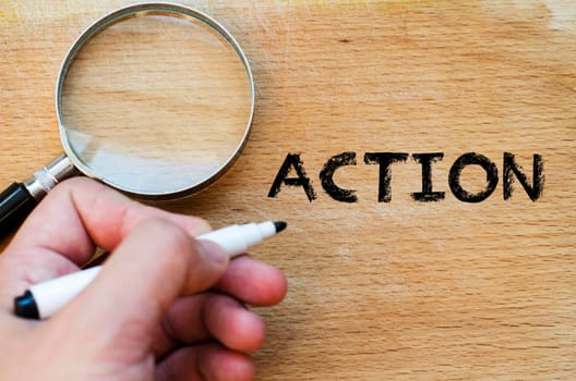 Human hand over wooden background and action text concept