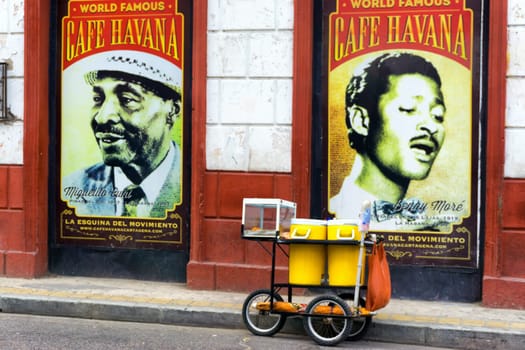 CARTAGENA, COLOMBIA - MAY 24: Food cart in front of posters for Cafe Havana, a bar known for live salsa music in Cartagena, Colombia on May 24, 2016