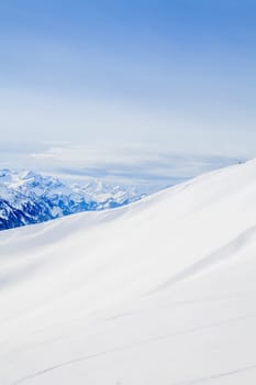 Winter snow covered mountain peaks in Europe. The Alps winter mountain landscape