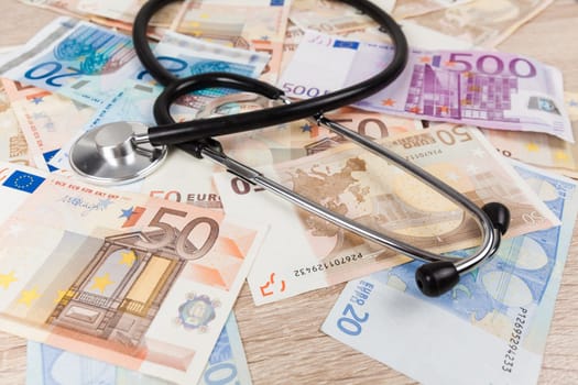 euro banknotes and stethoscope. Health care cost. medical concept