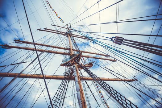 Detail of a sailboat rigging.  Mast on traditional sailboats. Mast of large wooden ship.