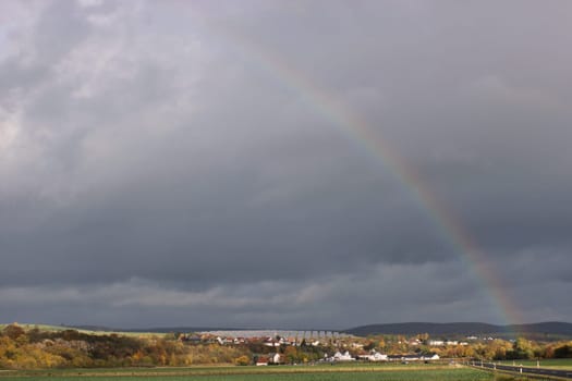 Rainbow over Lieschensruh and the solar park in the Edertal
