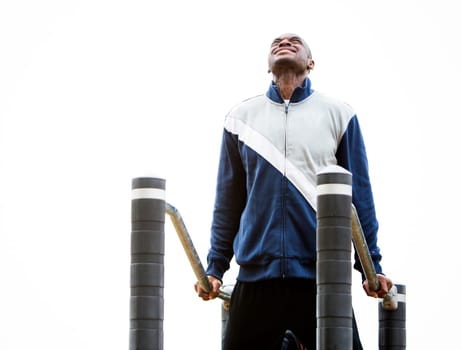 Active black man in training suit exercising at outdoor gym