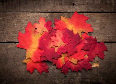 Autumn leaves decoration on a rustic wooden background