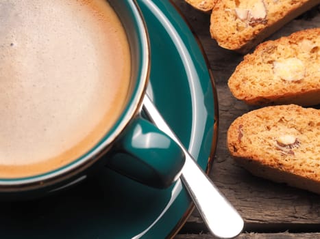 Closeup of Cantuccini with a cup of espresso on a wooden table