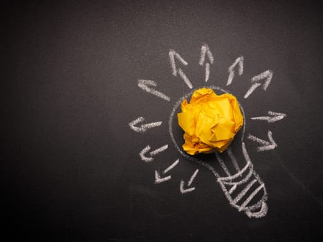 Crumpled paper with a hand drawn light bulb, many ideas concept