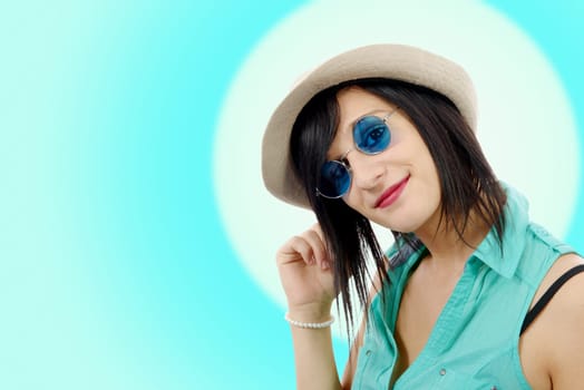 pretty young brunette woman with a summer hat and blue sunglasses
