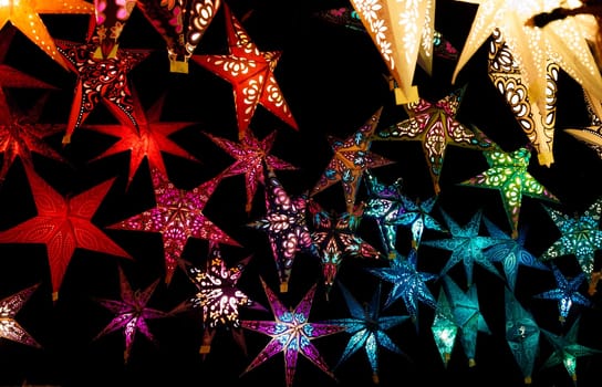 Colorful Christmas stars. A background of star lanterns