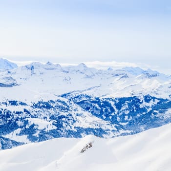 Winter snow covered mountain peaks in Europe. The Alps winter mountain landscape