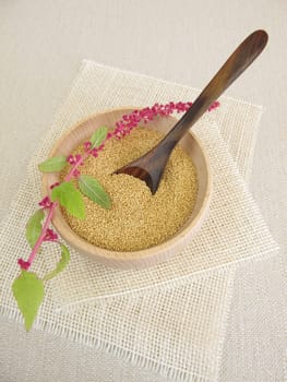 Amaranth grains in a wooden bowl