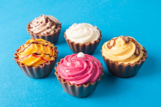 Birthday cupcakes on blue background. many sweet  cupcakes
