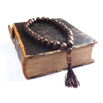 rosary beads on old books