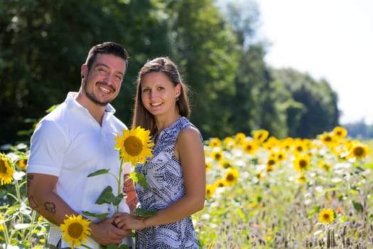 Happy young couple in the sunflower field,engagement,Bavaria,Germany
