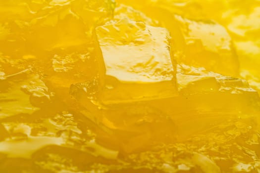 Horizontal close up of yellow jelly background texture