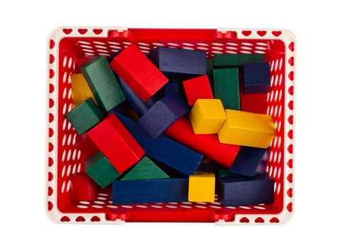 top view of red plastic shopping cart with colored wooden construction blocks isolated on white