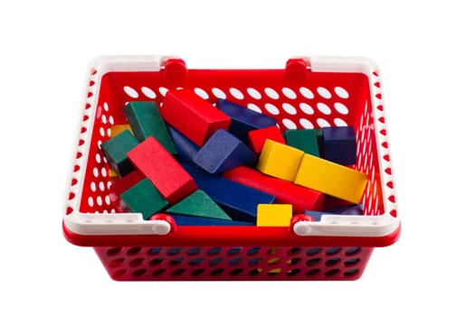 front view of red plastic shopping cart with colored wooden construction blocks isolated on white