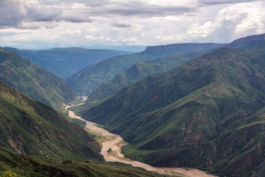 View of the rugged landscape of Chicamocha Canyon with Chicamocha River flowing below near Bucaramanga, Colombia