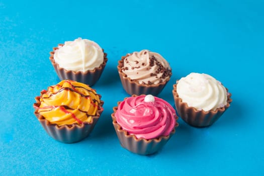 Birthday cupcakes on blue background. many sweet  cupcakes