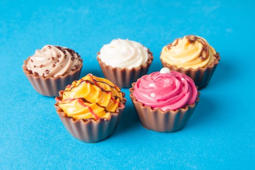 Birthday cupcakes on blue background. many sweet  cupcakes