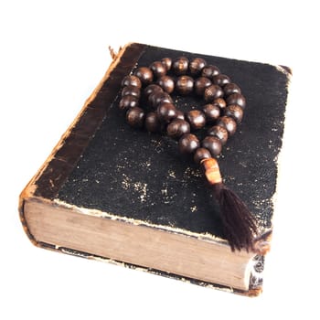 rosary beads on old books