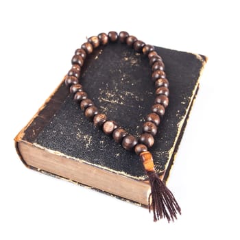 rosary beads on old books