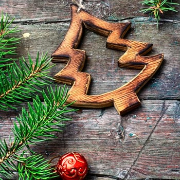 Christmas toy, vintage wooden Christmas tree on background with Christmas fir