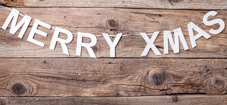 Merry Christmas sign on wooden background with copy space