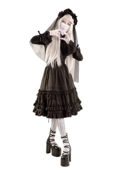 Widow in a black dress with white eyes looking like a doll isolated in white