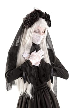 Widow in a black dress with white eyes looking like a doll isolated in white