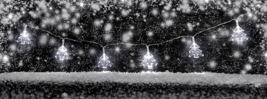 Traditional Christmas decoration lights with snow and copy space