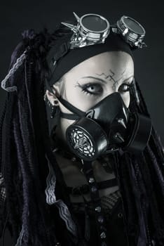 Cyber Gothic girl posing isolated in a dark background