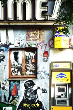 Berlin,Germany - May 09,2016: Graffiti and cartoonish street art next to an ATM in Friedrichshain on May 9,2016 in Berlin.