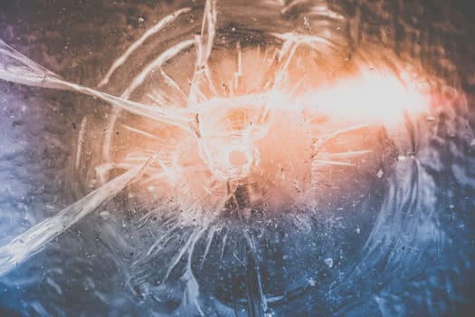 Illustration on the subject of accident damage - window with hole and dramatic lights