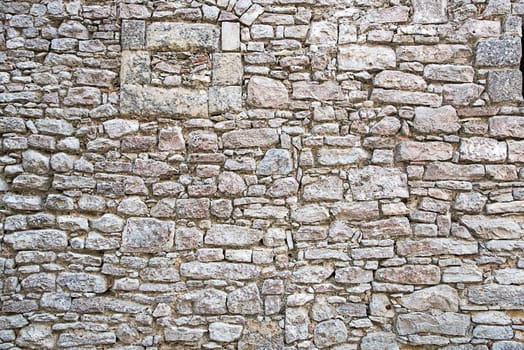 Background motif made of a coarse natural stone wall