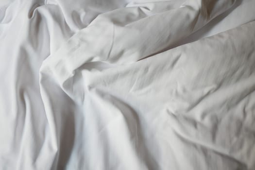 Gentle folds of white fabric create a serene and calming effect.
