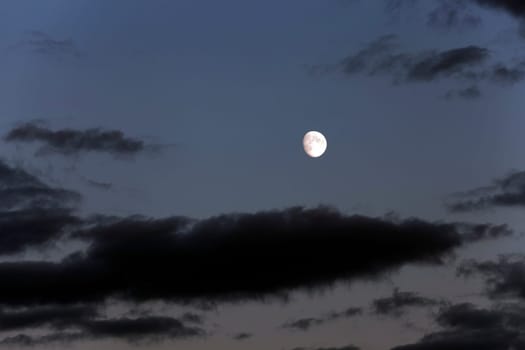 photographed the moon on a dark sky, a distant moon