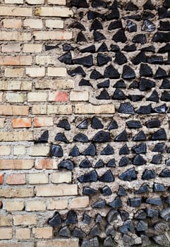 the building wall which is partially made of wooden logs