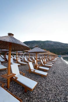 the wooden umbrellas located on a beach. Montenegro