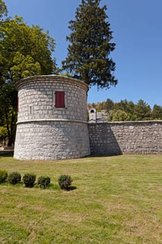 a tower with red shutters monastery, located in Cetinje, Montenegro