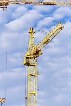 photographed close-up construction cranes during construction of a new multi-storey residential building
