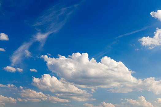 bright cumulus clouds are in the background of blue sky, close-up