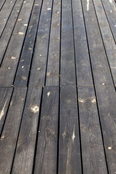 photographed close-up part of the wall made of planks, visible metal nails for attaching construction materials