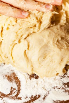 close-up photographed dough for baking a cake at home, the woman's hand can be seen