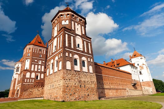 an ancient fortress located in the town of Mir, Belarus. Photo close-up, on background blue sky with clouds
