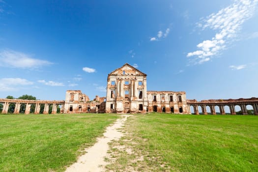 the ruins picture ancient fortress of the 16th century, situated in the village of Ruzhany Grodno region, Belarus, blue sky and a path on the lawn