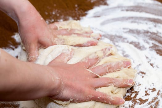close-up sfotograifrovannaya dough for baking a cake at home, the woman's hand can be seen