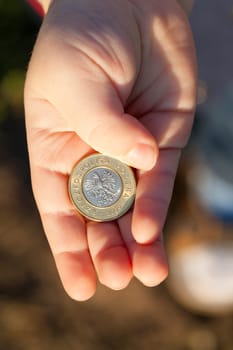 Polish zloty, photographed in the hands of a small child, close-up