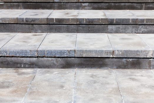 Photo broad steps made of concrete. Color gray structure, photographed at an angle and are visible plate