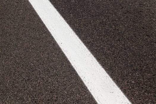 photographed close-up of road marking is located on the roadway, white line on the pavement