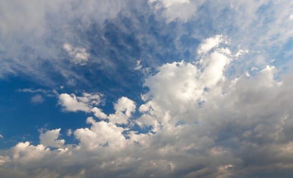 bright cumulus clouds are in the background of blue sky, close-up, de focus